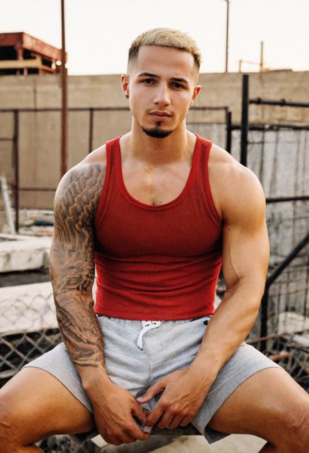 00036-2718932577-refined editorial photograph, photo of jordan_torres, relaxed confident expression, sitting, wearing a fitted red tank top and g.png